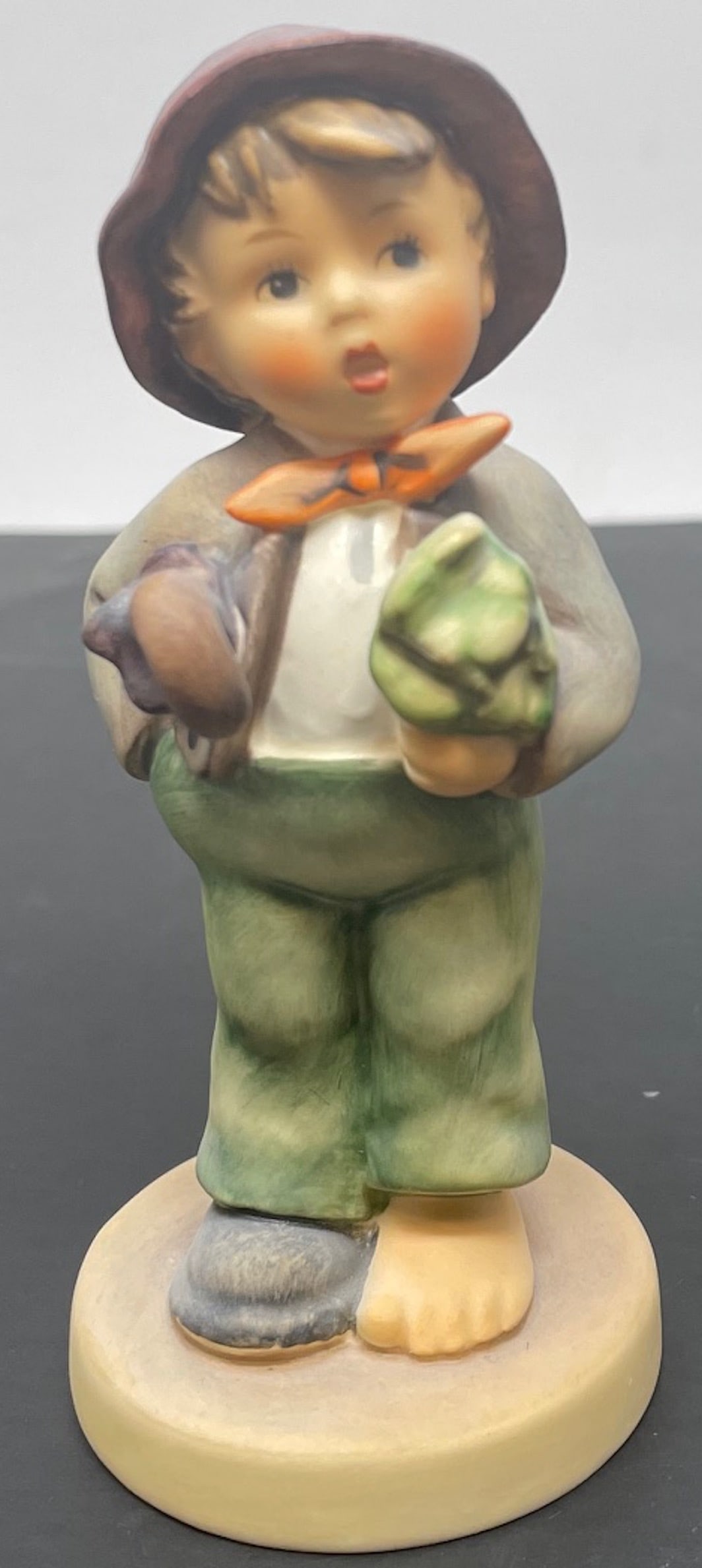 Goebel Hummel #374 "Lost Stocking" Figurine: Description: Goebel Hummel #374 "Lost Stocking" Figurine; measurement approximate: 4"h; material: porcelain