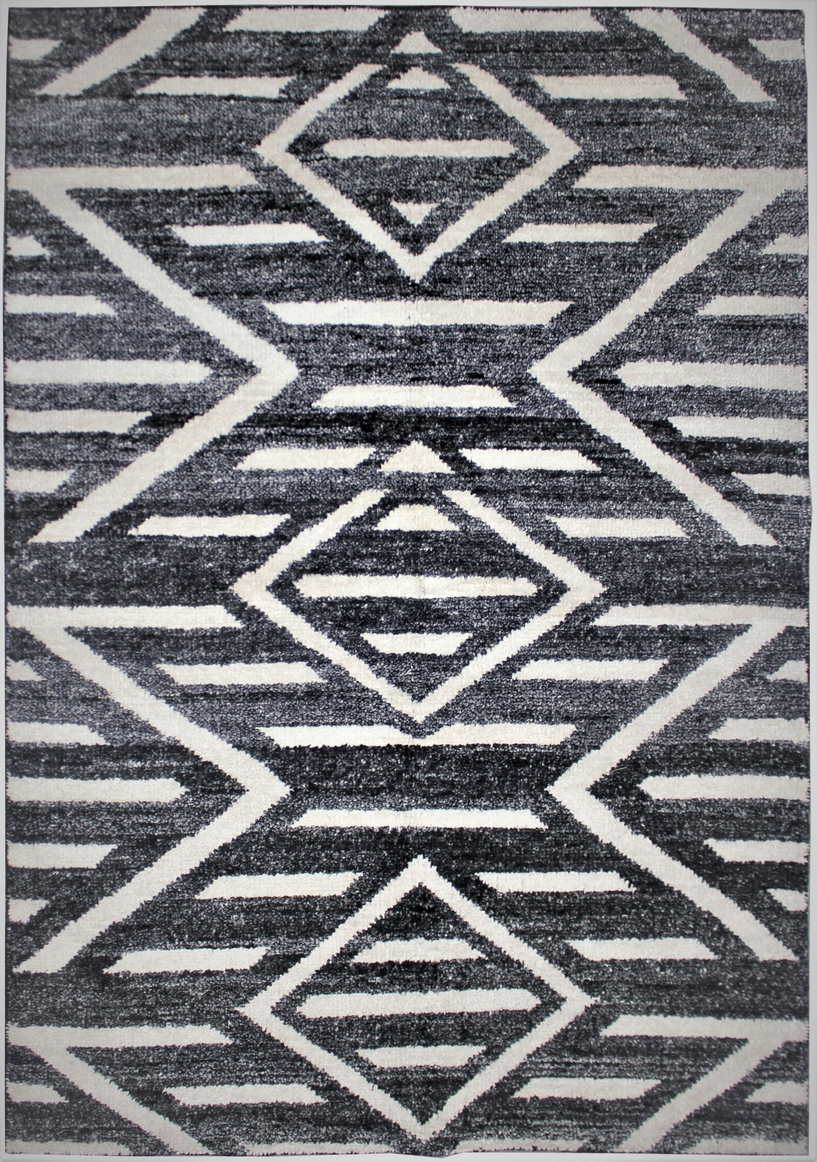 Handmade Bamboo Silk Rug. 9/12 Feet: A beautiful handmade environmentally friendly Bamboo and silk rug, with a geometric design is made of 75% bamboo silk and 25% cotton. The outstanding design, and very popular colors make this piece an