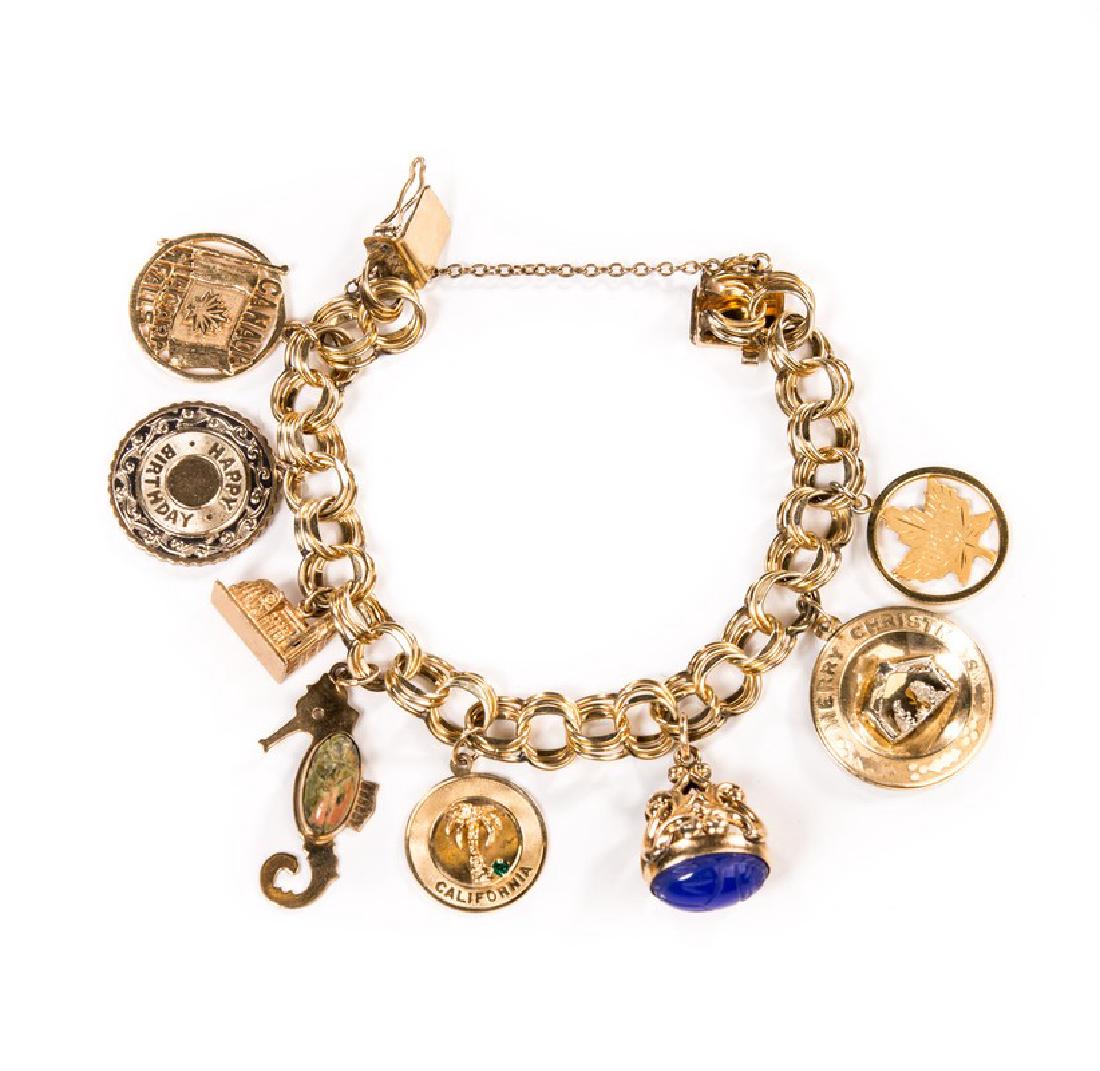GOLD CHARM BRACELET 8 CHARMS: Charms - "Toronto" maple leaf marked GF "Merry Christmas" cannot find mark Lapiz scarab California marked 14 kt Seahorse marked 1/20 12 kt gf WRF Building appears to be copper Happy Birthday - no mark