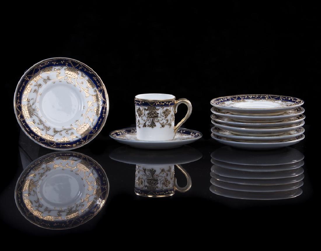 Set of 8 demi tasse blue and gold: Set of 8 Nippon porcelain demi tasse cup and saucers in cobalt blue with gilt trimming and scrolls. Measures approximately 4 1/8" diameter saucer and 2" h of cup.