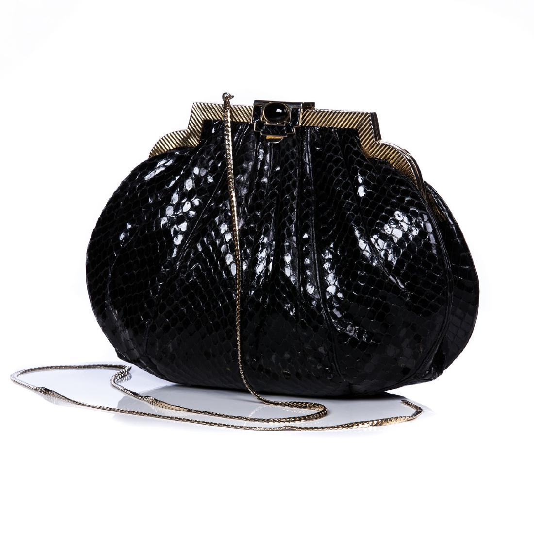 JUDITH LEIBER BLACK SNAKESKIN PURSE: Judith Leiber black snakeskin purse with black cabachon stone closure. Interior has zipper pocket and pouch. Gold tone hardware and detachable shoulder chain.