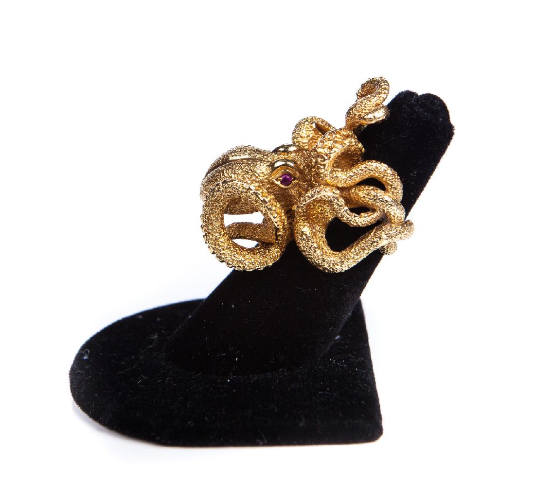 KW YG HAND MADE OCTOPUS RING W/ RUBY EYES: KW YG 18 kt hand made octopus ring with 2 ruby eyes. Heavy gold. Inscribed on inside of the ring not the shank KW 969 KW 18 kt and it weights 22.6 dwt. We believe this ring to be made by Kurt Wayne.