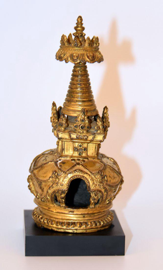 A finely cast Nepalese Stupa: A finely cast Nepalese Stupa C. 17th century or earlier Nepal, Gilt Bronze 7 in. (18 cm)