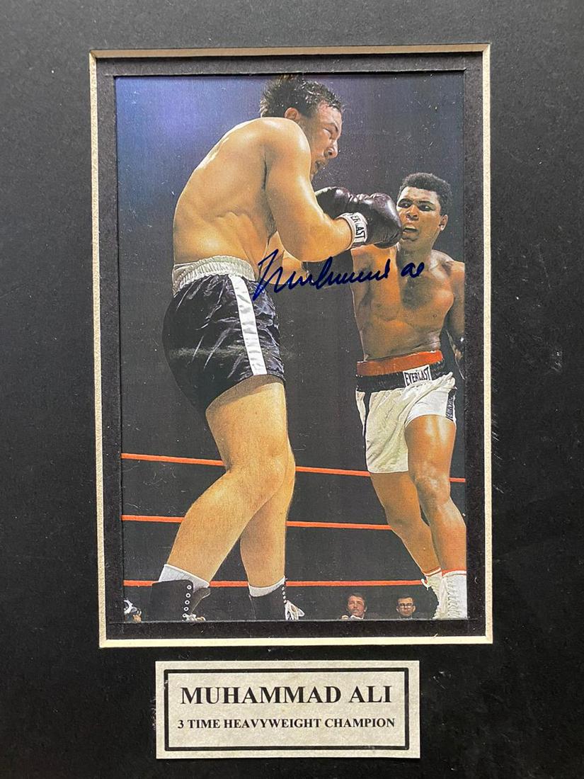Autographed Muhammad Ali & Boxer (Matted) Photograph: Autographed Muhammad Ali pushing boxer, Matted Medium: Autographed Photograph Note: Dimensions provided include matting
