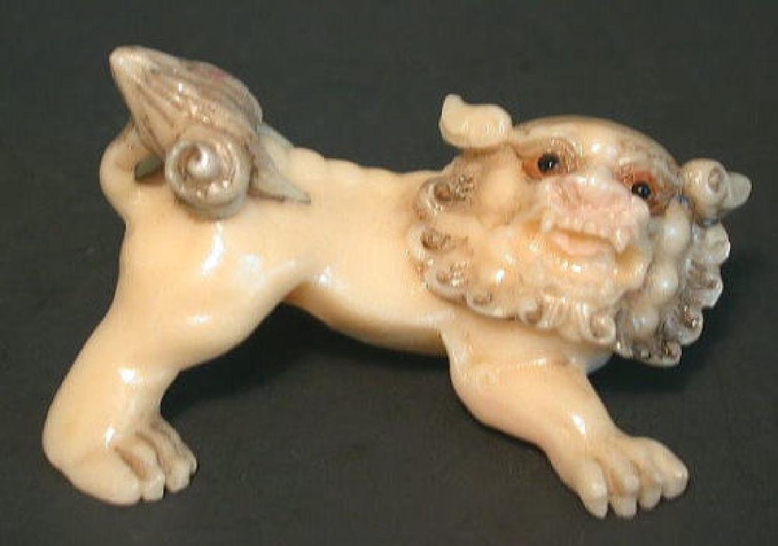 Japanese ivory color bone netsuke -: netsuke size good condition. Probably a middle eastern lion offered to the Chinese emperor as a gift,but ran away into the wildeness. Made of bovine bone