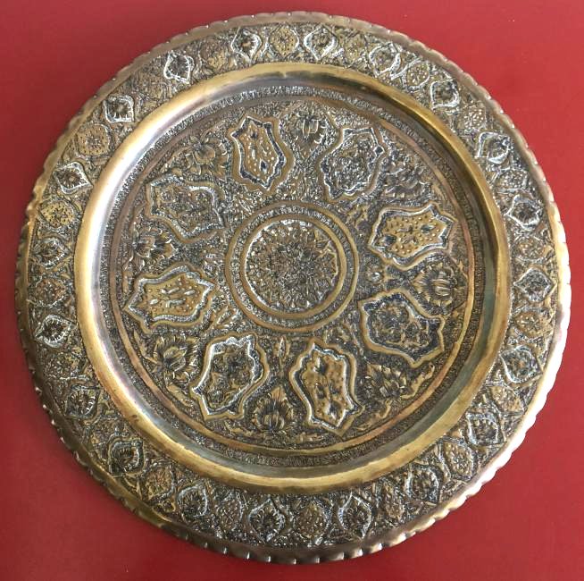 Antique Middle Eastern Brass Etched Tray: Antique brass Middle Eastern tray/wall hanging. Etched design throughout. A hook for hanging on the back. In good condition for its age. Measures approx. 16" diameter, .25" height. From a local, priva