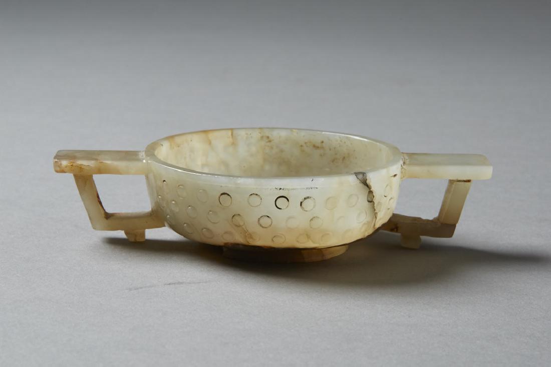 Chinese 18th C. Jade Double Handled Cup - BTC Acpt: An exceptional Chinese double handled cup carved from a beautiful pale jade with inclusions. Likely 17th century. Lovely hand polish. Dimensions: 7/8 in. x 3 6/8 in. x 2 2/8 in. Notes: For more inform