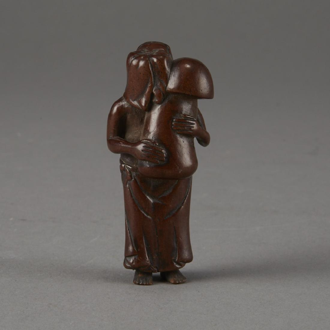 Japanese Edo Period Boxwood Netsuke of a Woman: A wonderful netsuke carved into the form of a woman with her head upturned, while holding a massive and rather phallic mushroom. Perhaps a less subtle form of Shunga. Wonderful wear and patina. Dimens