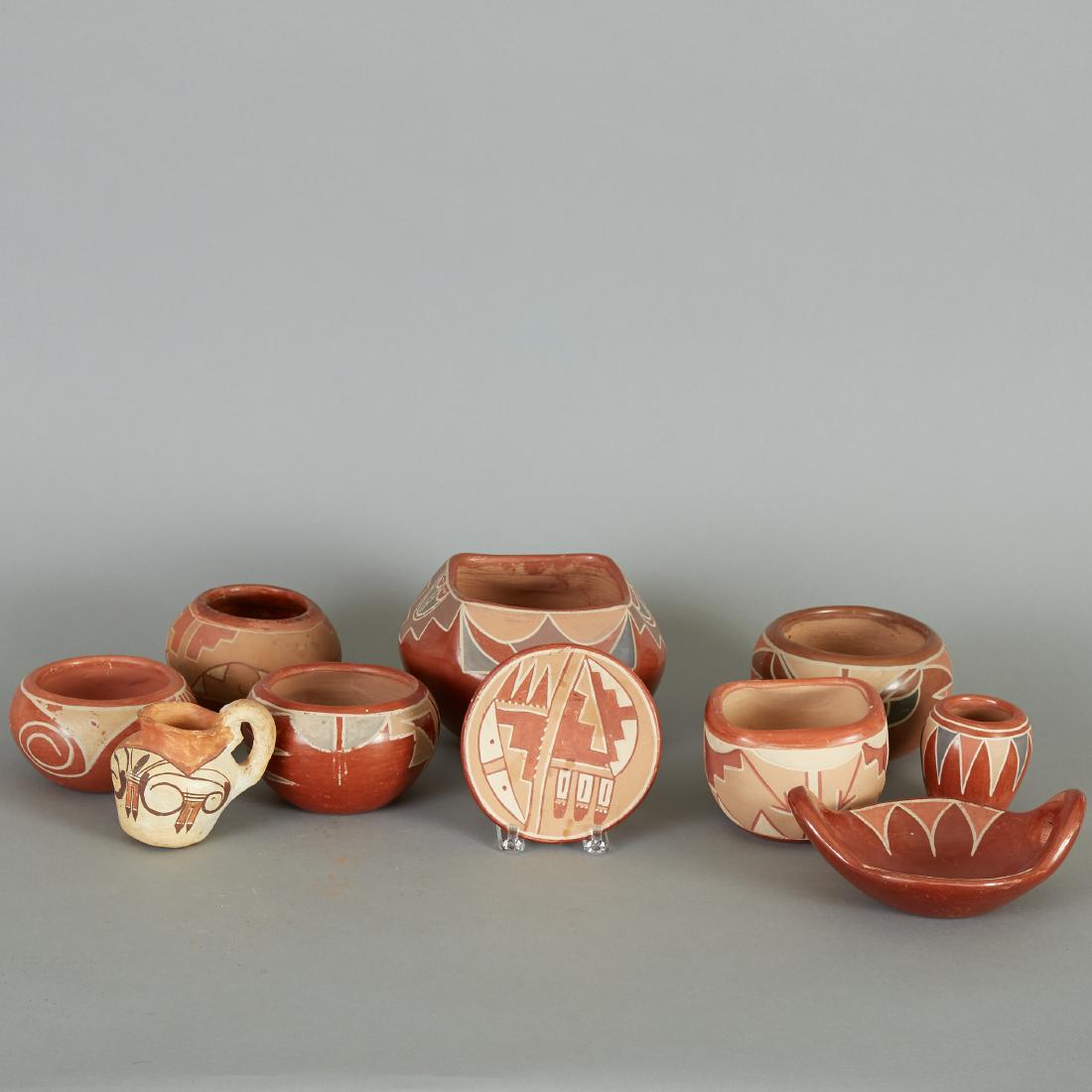 10 Native American Southwestern Redware Pots: Group of ten Southwestern redware pots, decorated in geometric patterns. Dimensions: Heights range from 1 in to 4 1/2 in. Diameters range from 2 3/4 in to 6 1/2 in.