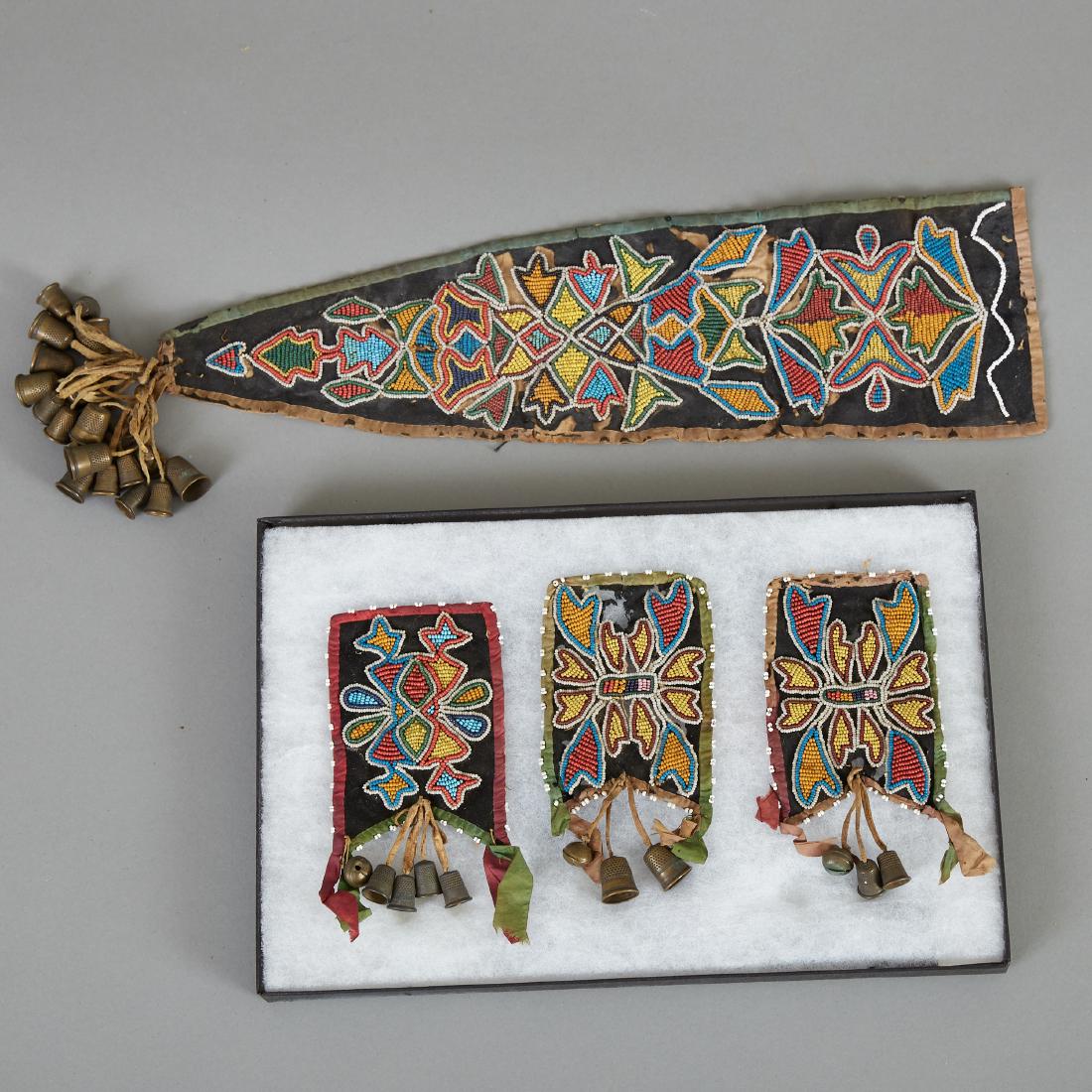 Ojibwe or Potawatomi Otter Pelt Medicine Bag Remnants: Ojibwe or Potawatomi otter pelt medicine bag remnants with beaded embellishments and felt backing. Contains three fragments of paw decorations with thimble and hawk bell tassels, and an embellished ta
