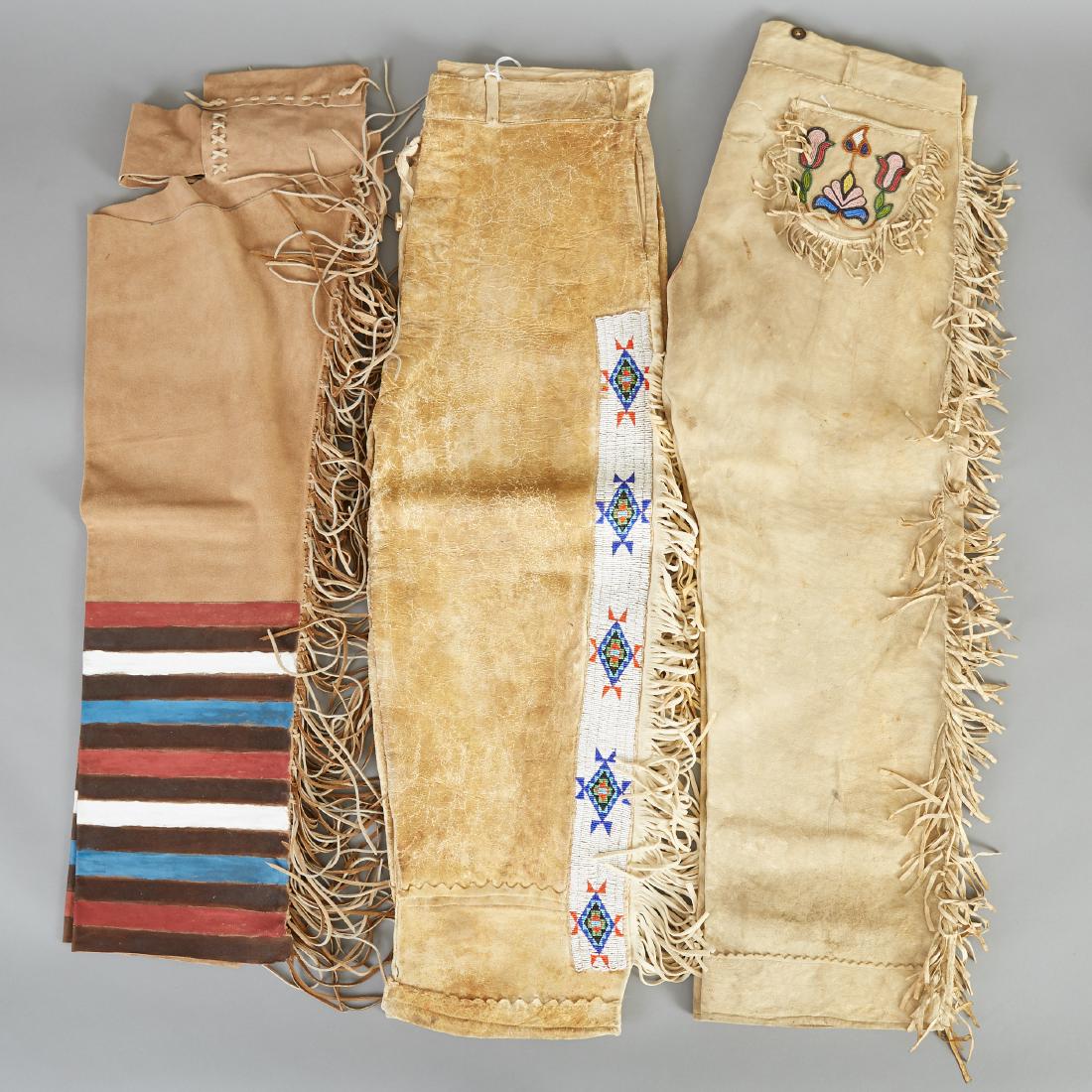 3 Pairs Native American Leggings Santee Sioux Cheyenne: Group of three pairs of Native American leggings. One pair of Santee Sioux brain-tanned hide leggings with beaded pockets and fringe reputedly used as a costume in Buffalo Bill's Wild West Show; one p
