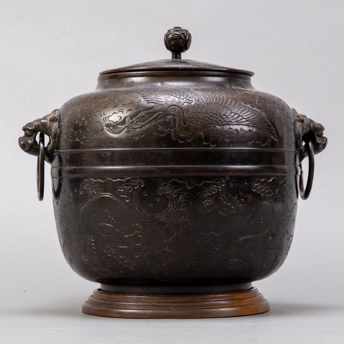 19th c. Japanese Covered Bronze Pot in Oval Form: An excellent Japanese Meiji bronze container with lovely deep red patina. In an oval form. Surfaces bear incised dragon and phoenix motifs. Likely an element of the tea ceremony. Dimensions: Height: 1