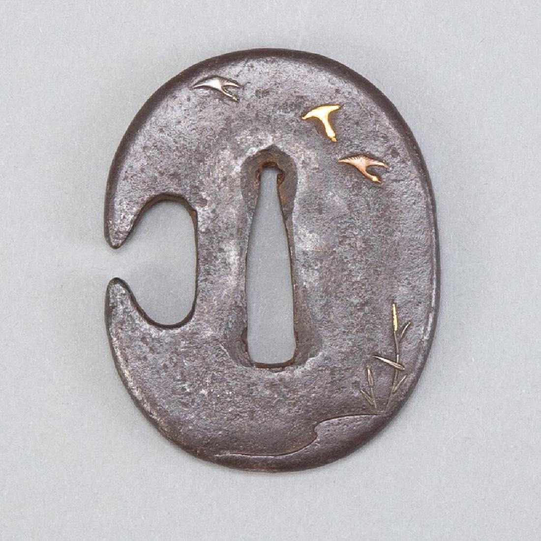 Japanese Edo Iron Tsuba with Birds and Reeds: Japanese Edo iron tsuba with gold inlay. Features birds and reeds in low relief on both sides. Dimensions: Height: 2 1/2 in x width: 2 in. SKU: 00736
