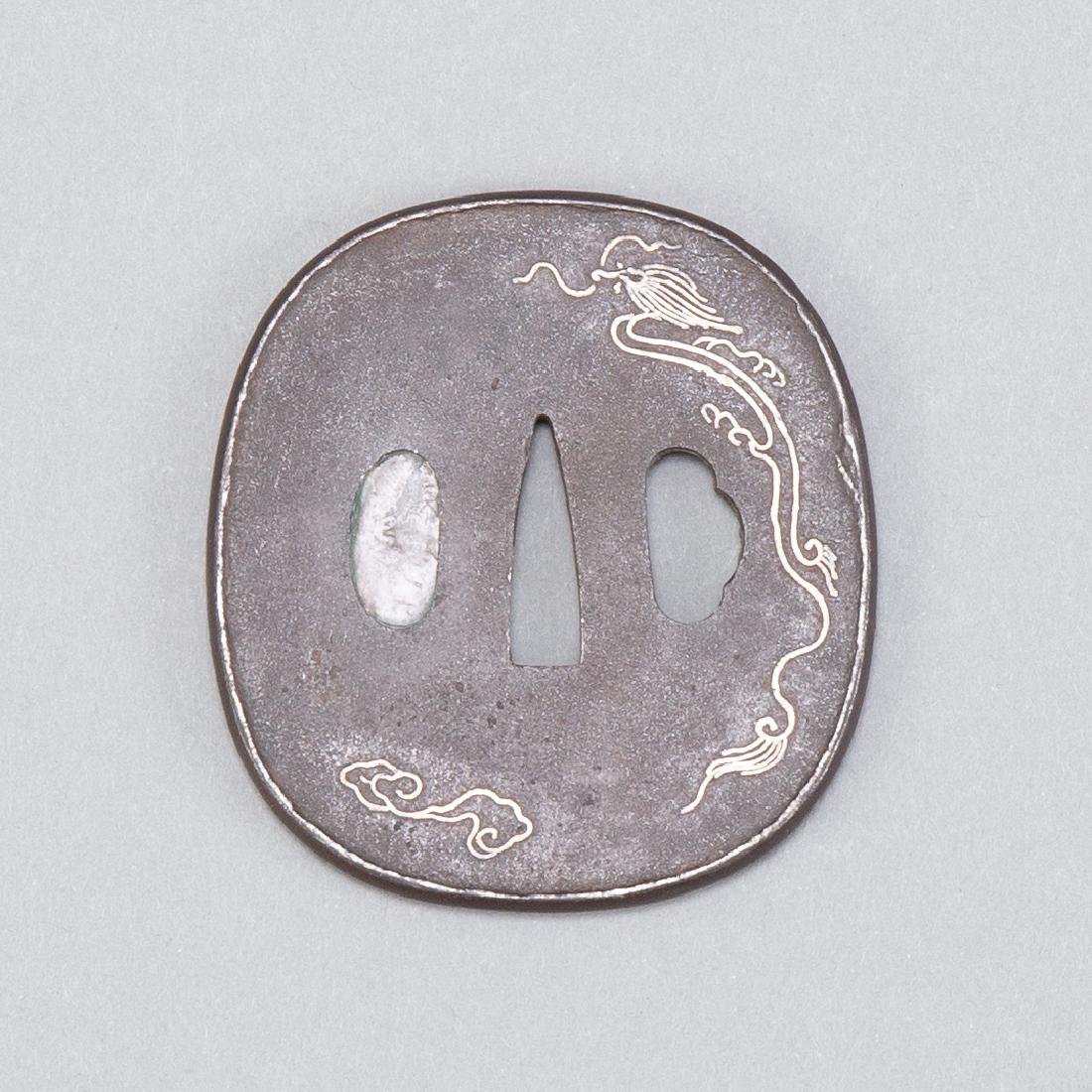 Japanese Edo Period Iron Tsuba with Silver Inlay: Early 18th c. (Edo Period) Japanese iron tsuba with silver inlay dragon. Classic example of tsuba in the Higo School. Dimensions: Height: 3 in x width: 2 3/4 in. SKU: 01088