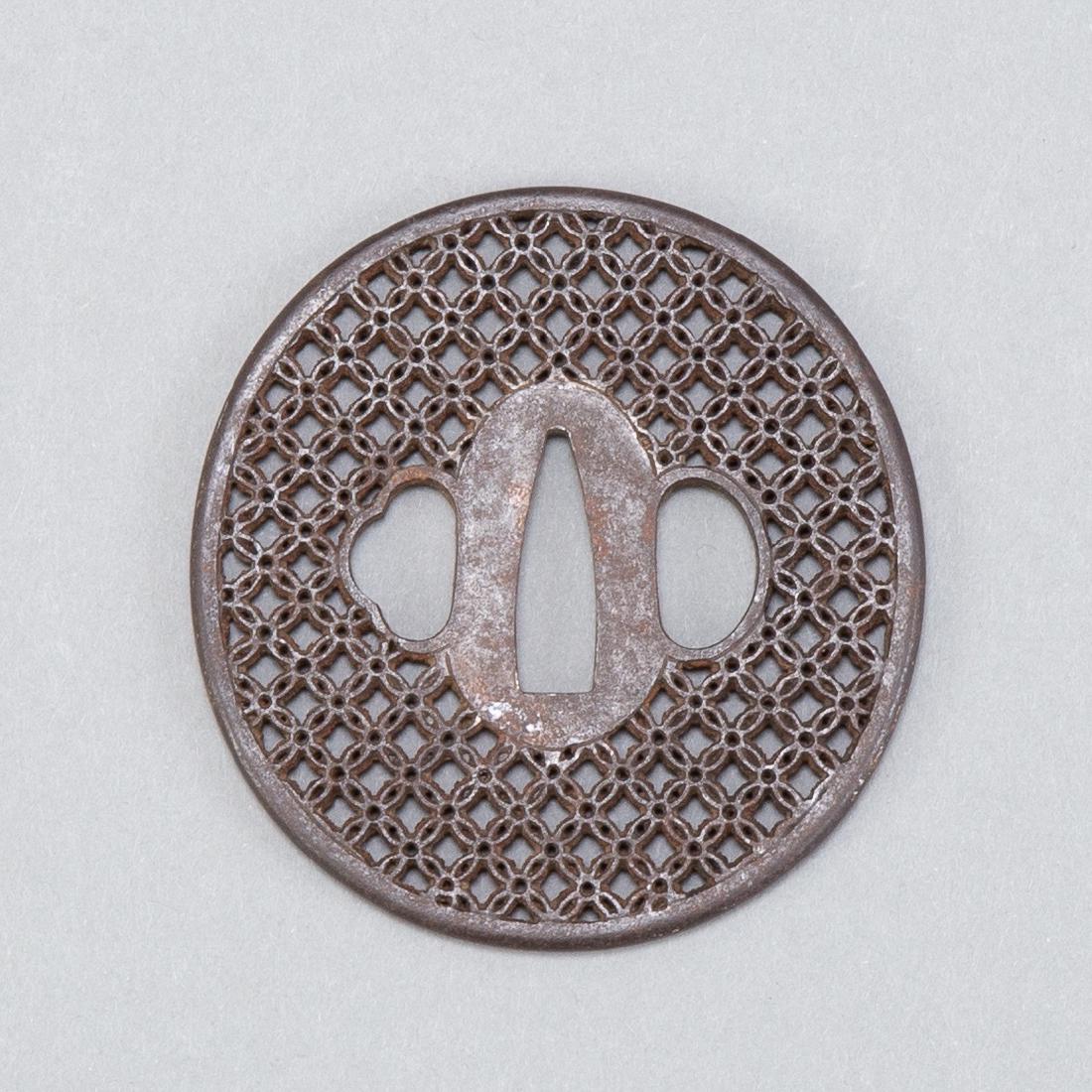 Japanese Edo Period Iron Tsuba Surface: Early 18th c. (Edo Period) Japanese iron tsuba. Features reticulated pattern throughout. Kyo-Sukashi School. Dimensions: Height: 3 1/4 in x width: 3 in. SKU: 01092