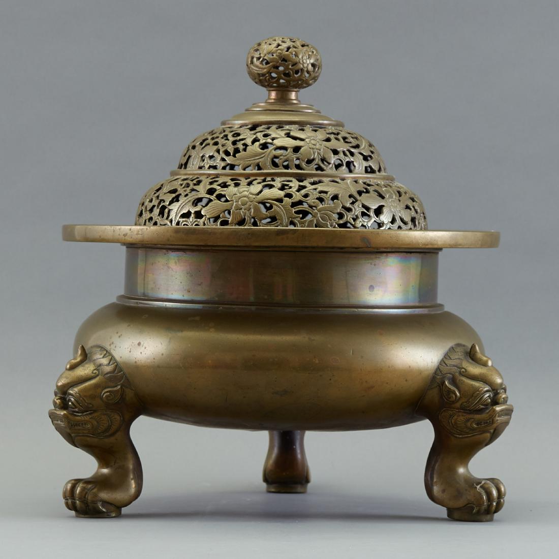 19th c. Chinese Covered Bronze Brazier or Censer: A very large and well cast Qing Chinese bronze tripod censer or brazier for a temple or large important home. The top is heavily cast and worked with reticulation. There is evidence of a recent re-pol