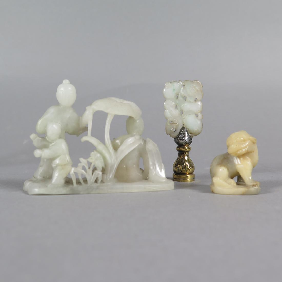 Group Chinese Jade and Soapstone Carvings Late 19: Group of three Chinese jade and soapstone carvings from the late 19th and early 20th c. Includes one soapstone foo dog, one jade carving of children with plants, and one jade plaque mounted as a lamp 