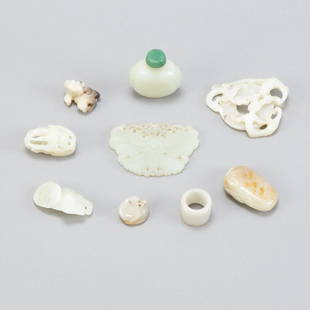 8 Small Jade Objects w/ Archery Ring Snuff Bottle: A grouping of Chinese Qing Dynasty pale jade celadon carvings including a lovely jade butterfly plaque, a well carved archers ring. A jade snuff bottle. Several small hand carvings. All of fine qualit