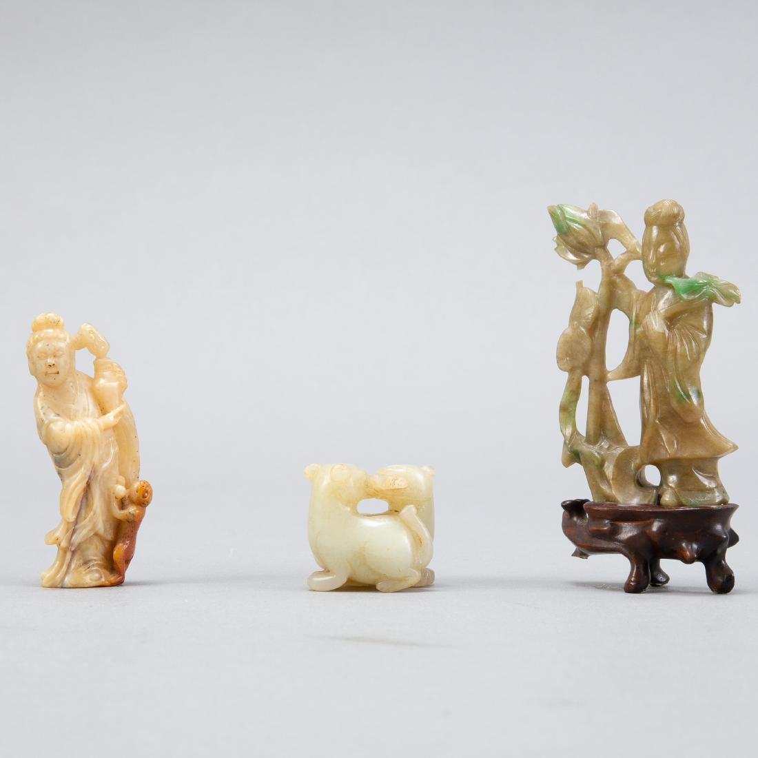 Grp:3 Chinese Carved Stone/Jade Figures Qing: Group of 3 small Chinese carved stone figurines. The carved soapstone figure depicting a maiden holding a vase with a monkey at her feet is of the early Qing Dynasty. It is carved in a manner to highl