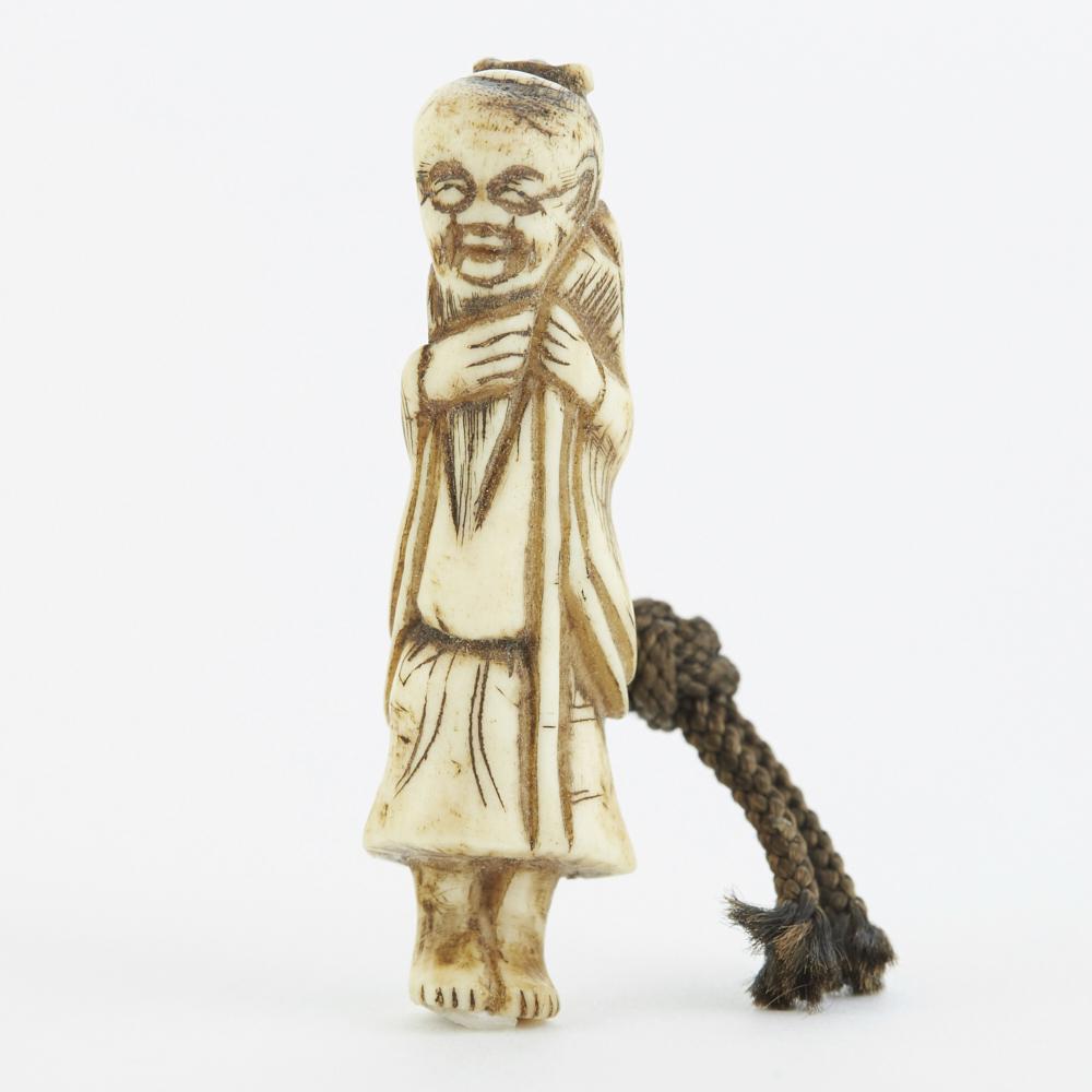 Edo Japanese Antler Netsuke of a Man: Edo period Japanese carved antler netsuke in the form of a man. Dimensions: Height: 2 1/2 in x width: 3/4 in x depth: 1/2 in. SKU: 02384