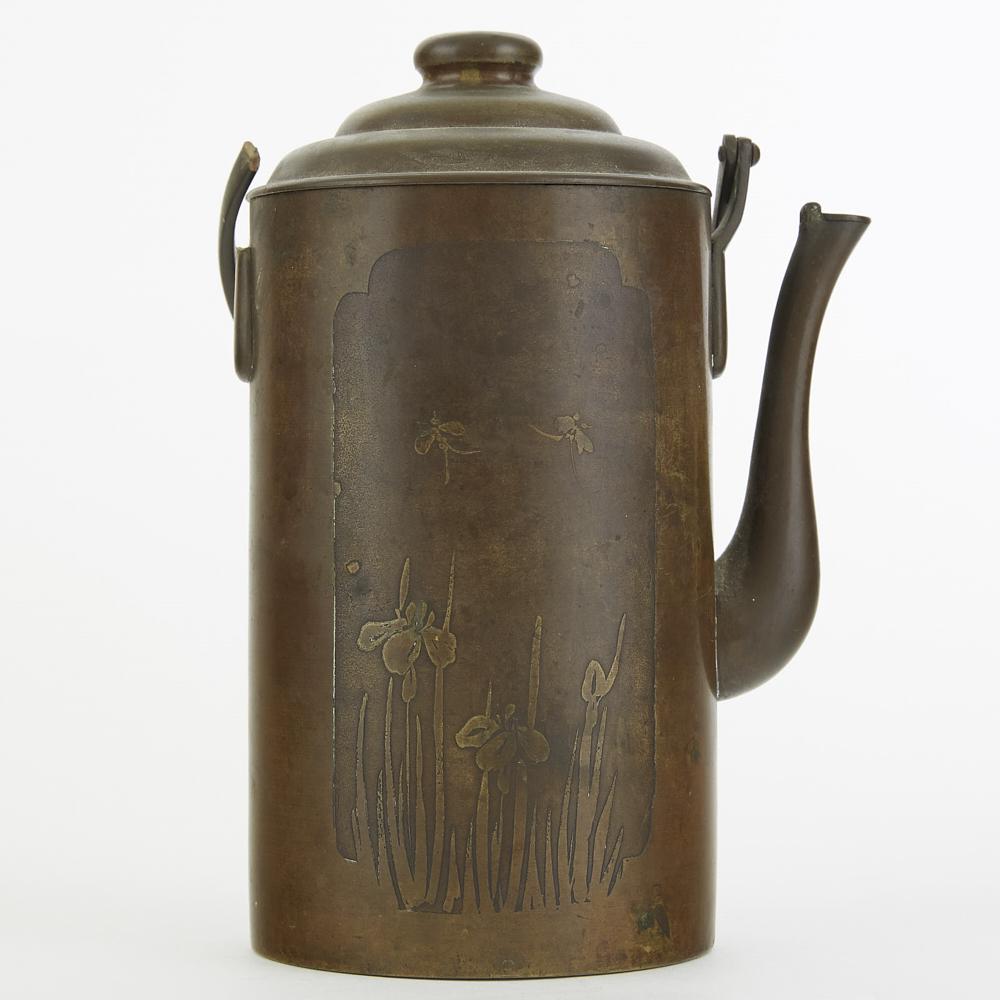Chinese Etched Brass/Copper Kettle: A 20th C. Chinese etched brass and copper kettle. One side decorated with a reserve of irises and dragonflies, the other with a reserve of calligraphy. Dimensions: Height (including handle): 10 in x w