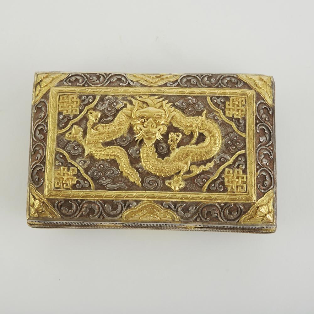 Late 19th/Early 20th c. Chinese Silver and Gold G: A stunning example of early 20th century Chinese silver repousse work, this silver box with hinged lid is decorated throughout and features a gilded dragon on the lid. Dimensions: Height: 2 1/2 in x l