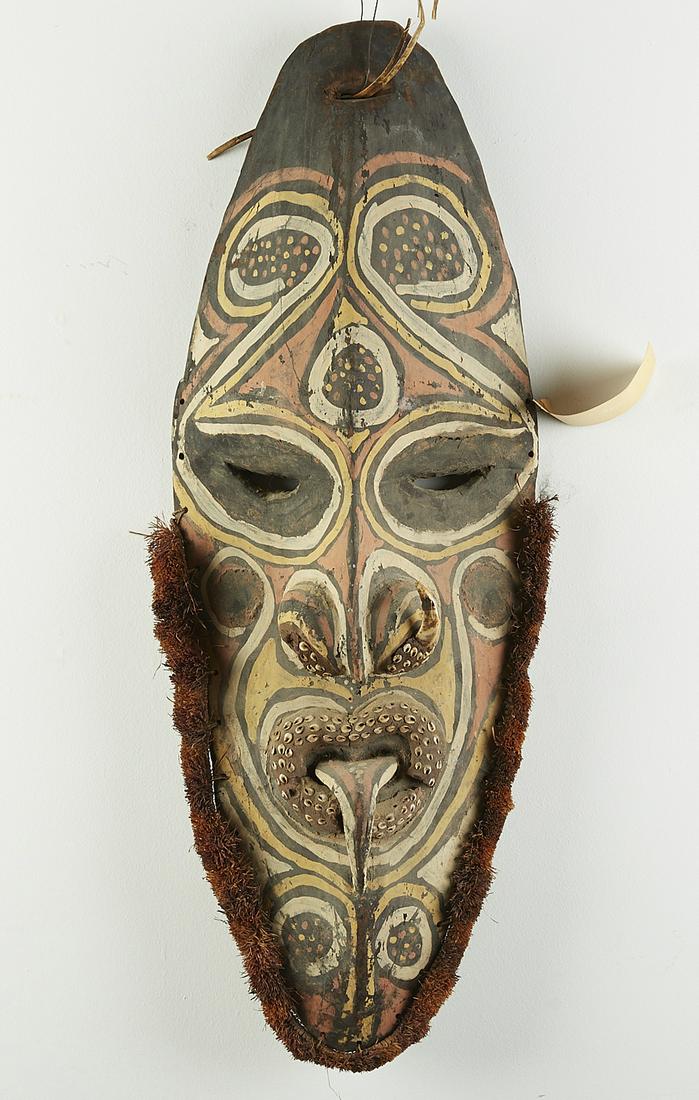 Papua New Guinea Sepik River Mask: Papua New Guinea Sepik River mask. Carved and painted wood with cowrie shells set in clay and a boar tusk along the nose. Possibly deaccessioned from the University of Nebraska Museum collection in th