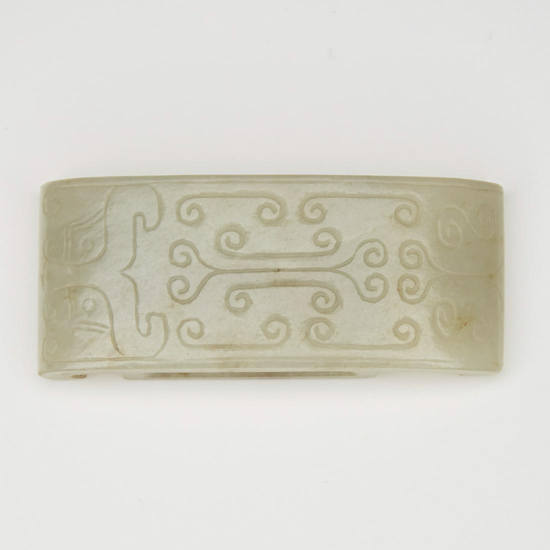 One Chinese Jade Belt Slide with Incised Decorati: Very well polished Chinese jade belt slide. Excellent form and style, featuring delicate incised decoration. Dimensions: Height: 2 1/2 in x width: 1 in. SKU: 03060