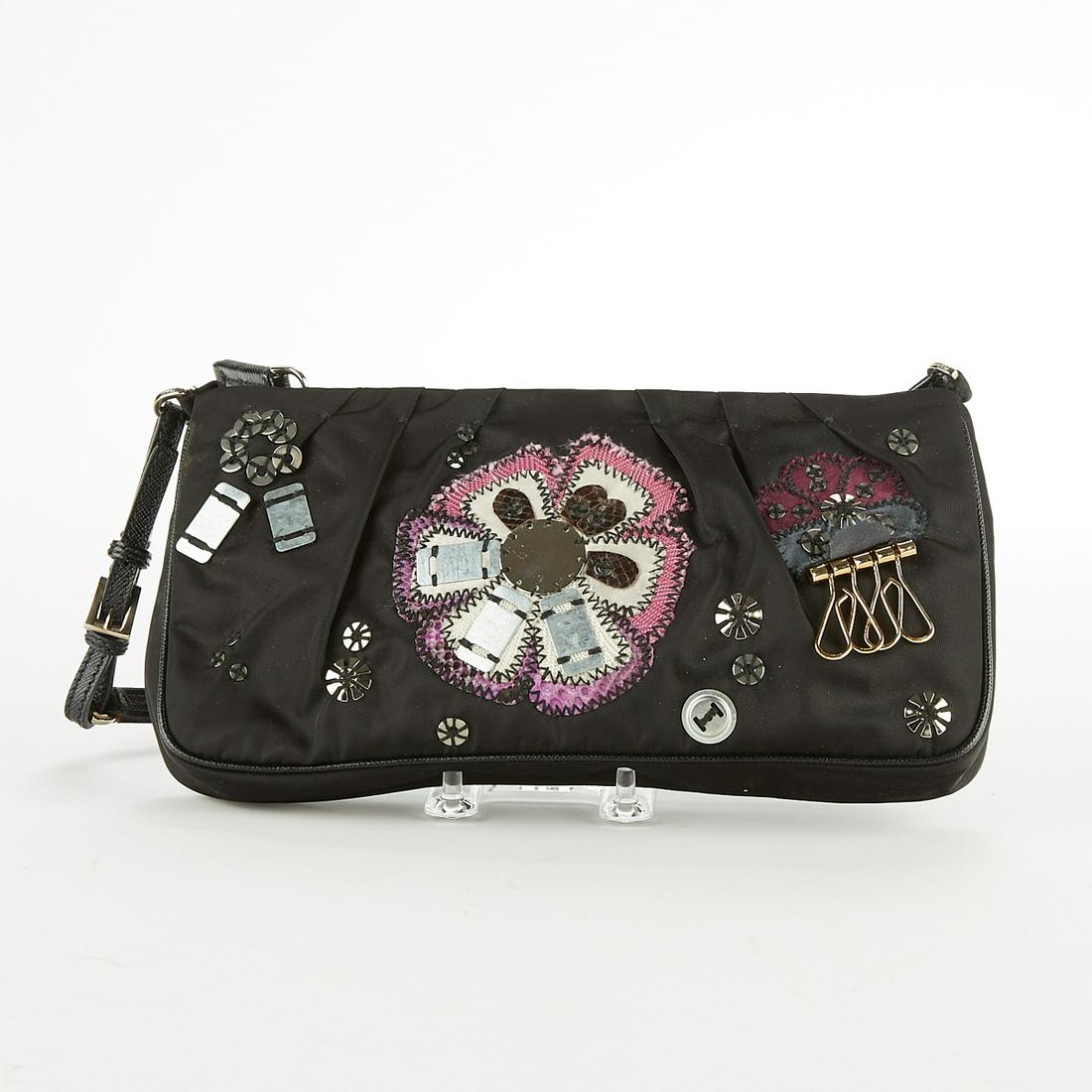 Prada Black Handbag w/ Appliques Purse: Prada, Italy. Black handbag with several metallic applique elements in a floral motif. Zipper closure. One zipper pocket along the interior. Metal tag reads "Prada Milano dal 1913." SKU: 03245