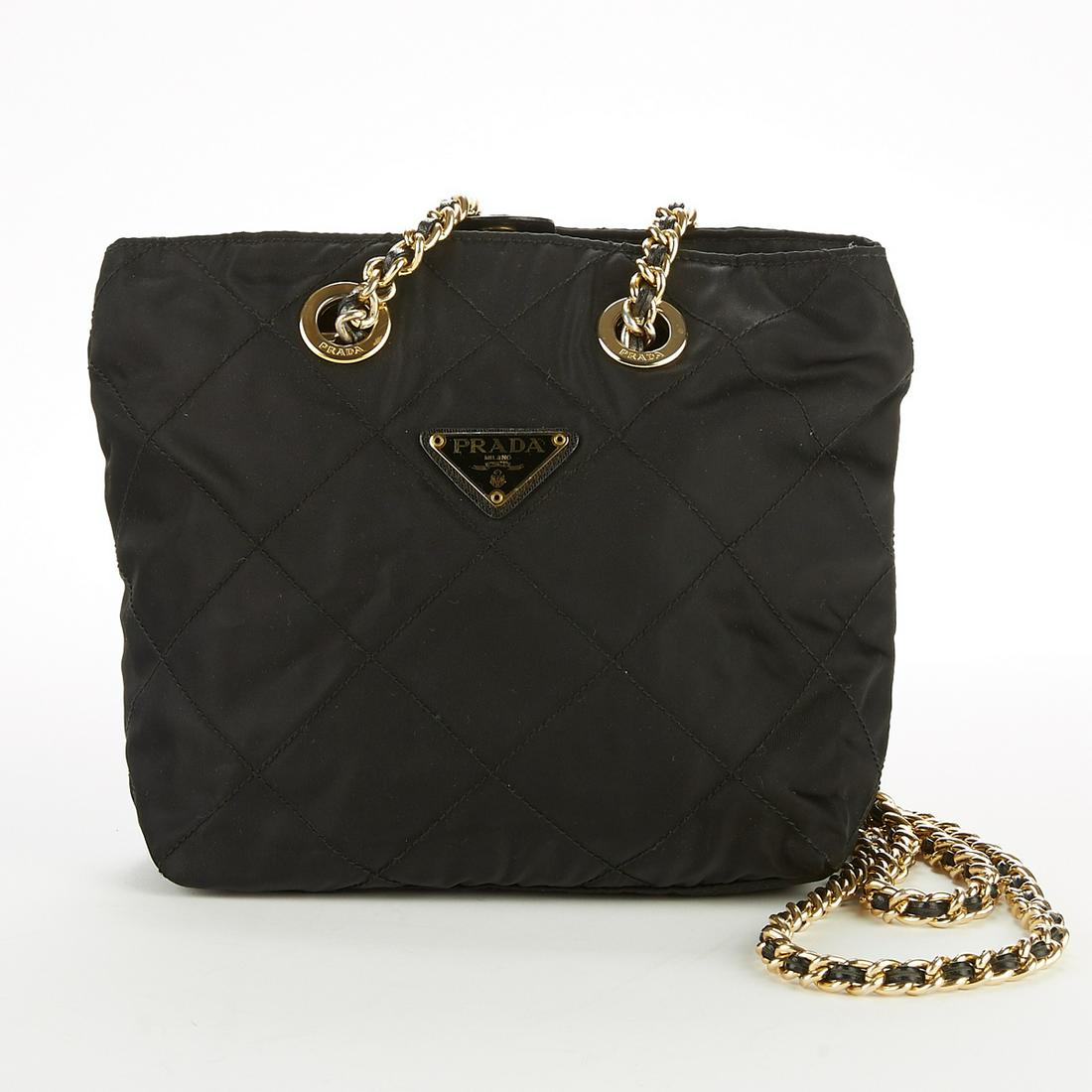 Prada Black Quilted Handbag w/ Gold Chain Strap P: Prada, Italy. Black quilted handbag with gold tone hardware and chain strap and a snap closure. One zipper pocket along the interior. Metal tag on the front reads "Prada Milano dal 1913." SKU: 03246