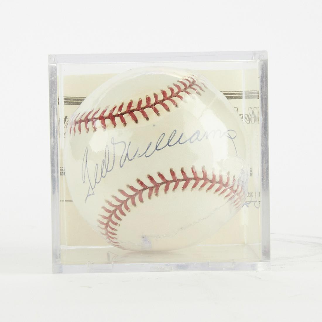 Signed Baseball Ted Williams: One baseball signed by Ted Williams. Ball is in a shadow box with a certificate of authenticity confirming that the autograph is authentic. Dimensions: Height: 3 1/4 in x width: 3 1/4 in x depth: 3 1/