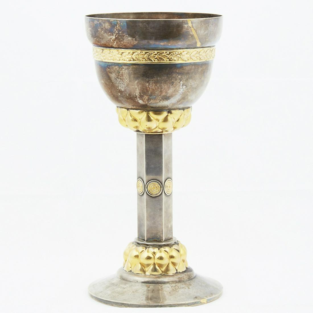 German Arts and Crafts WMF Chalice Trophy: German Arts and Crafts WMF chalice trophy, silver on nickel plated with gold gilt. Engraved "Ehrenpreis, P.H.V. Prusung, Hannover 14.-15.5.1911." Dimensions: Height: 11 1/4 in. SKU: 03826