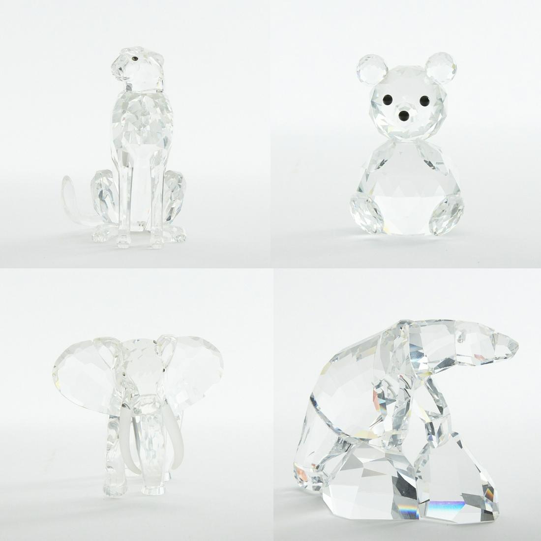 Grp: 4 Swarovski Crystal Animals: Group of four Swarovski Crystal animals including one bear, cheetah, Nanuc polar bear, and 1993 "Inspiration Africa" elephant. Dimensions: Height range: 2 1/2 in - 5 in. Width range: 1 1/2 in - 6 1/2