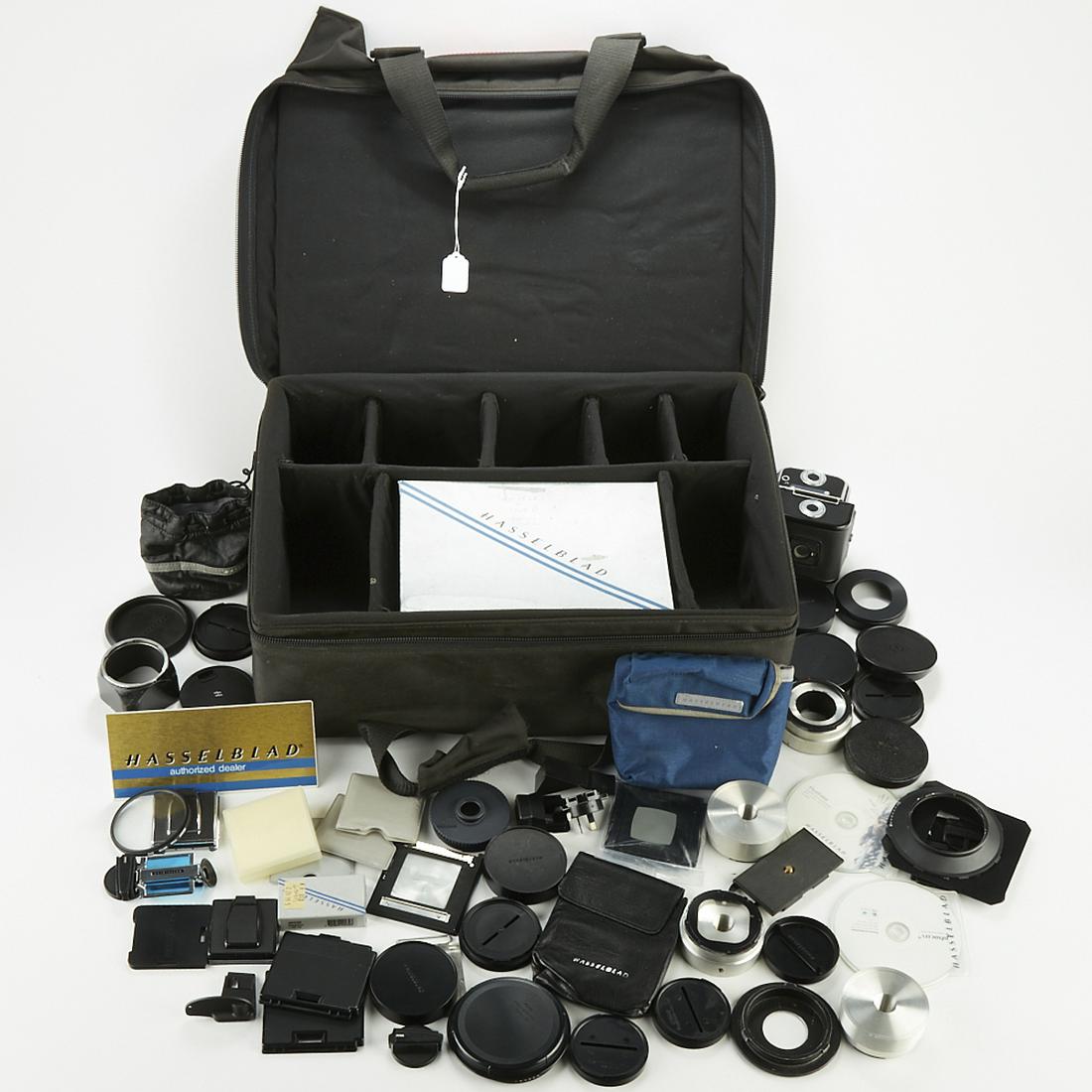 Large Group of Hasselblad Camera Accessories: Large group of Hasselblad camera accessories, including two backs, a flexbody, many lens caps, filters, and other viewfinder accessories. Includes soft pack case and vintage Hasselblad briefcase. SKU: