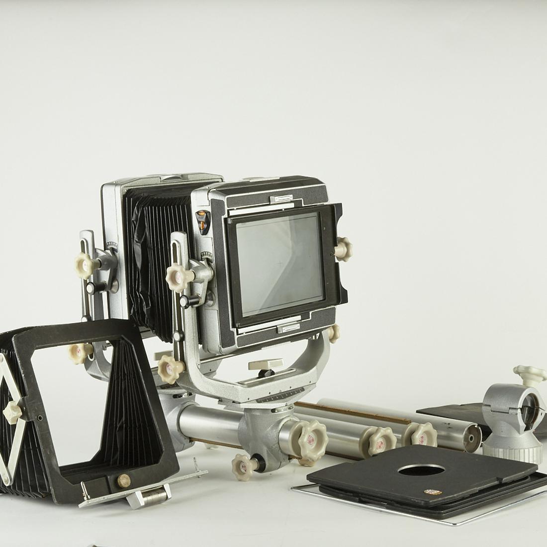 Linhof Kardan Color Large Format Monorail Camera: Linhof Kardan Color large format monorail camera. With several extra lens boards. Includes a period Linhof aluminum travel case. Not tested for light leaks. Billows show signs of damage. SKU: 03330
