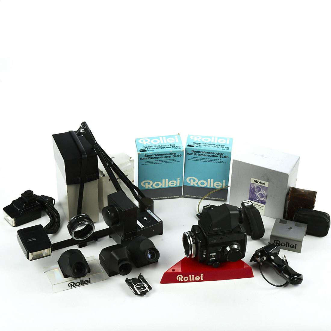 Grp of Rollei Camera Accessories: Group of Rollei camera accessories. Includes a retail display stand; one Rollei 25 (not tested); one Rolleimot Rollei Werke Franke & Heidecke; a lens extension tube, a set of bellows, three lens hoods