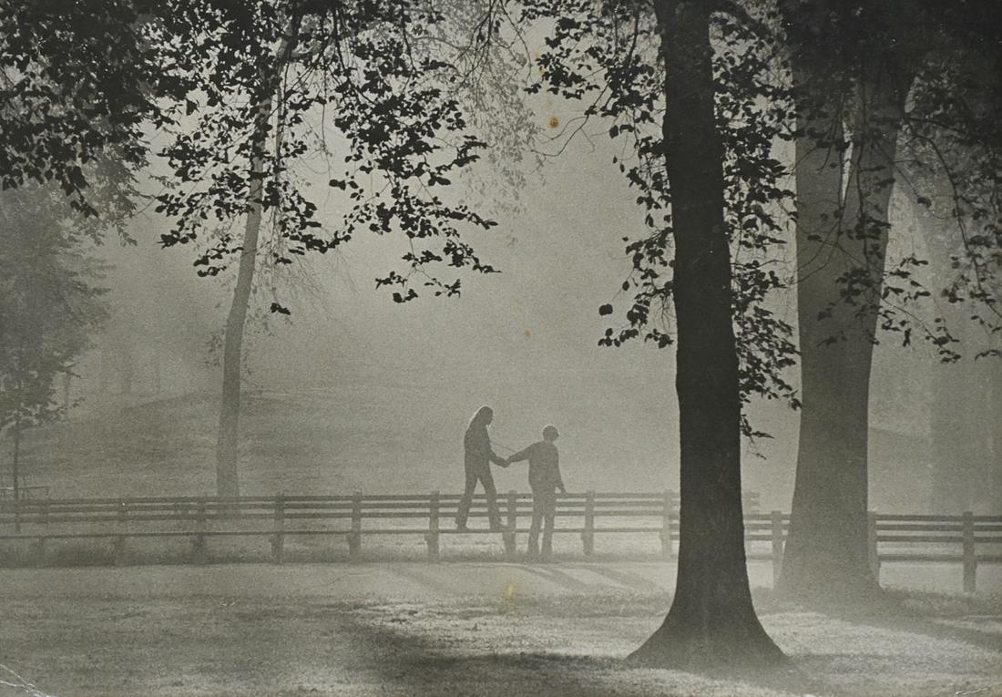 Esther Bubley Photograph Couple Central Park: Esther Bubley (1922-1998). Photograph depicting a couple holding hands and walking along a fence among trees in Central Park. Silver gelatin print. Inscribed "Central Park, 1974" along the verso, and