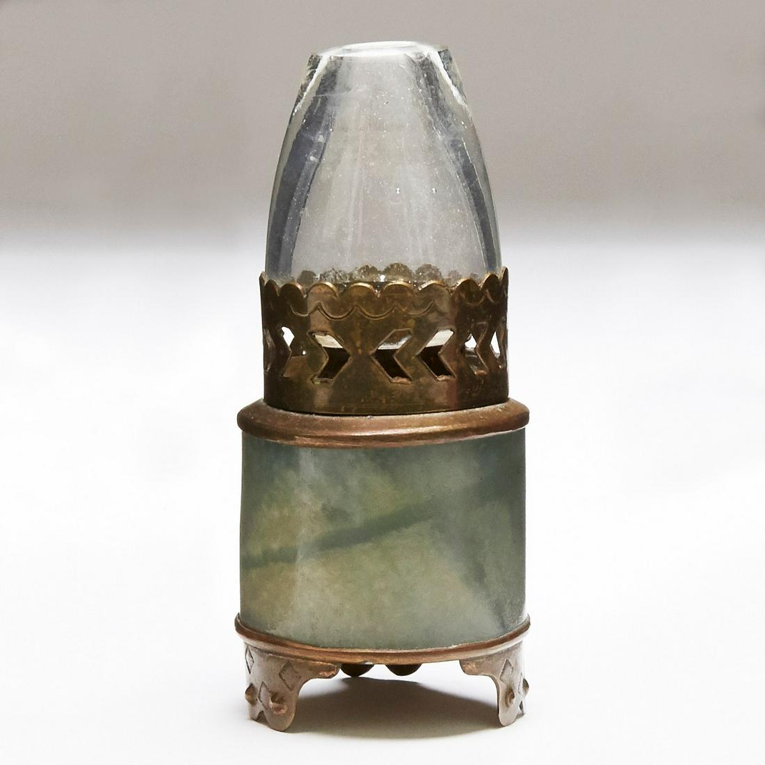 Chinese Serpentine or Jade Oil Lamp Made from Archers: Small Chinese oil lamp made of a jade or serpentine archer's ring. Marked "Hong Kong" along the underside. The type of lamp often used for smoking opium.Height: 3 3/4 in x diameter: 1 3/4 in