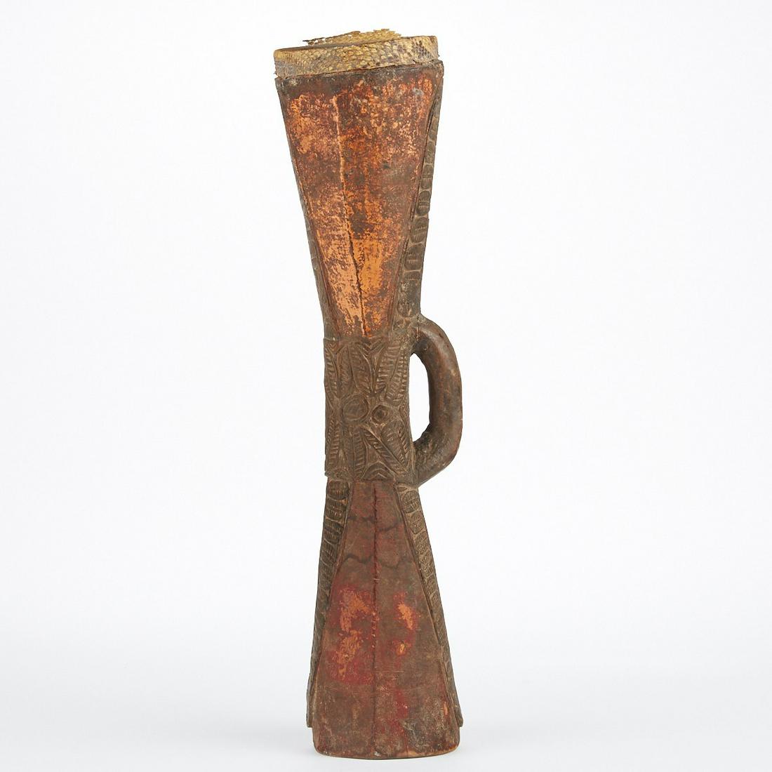 Papua New Guinea Sepik River Hand Drum: Papua New Guinea Sepik River hourglass shaped hand drum (kundu). Wood body with detailed geometric carvings reptilian drum surface. Height: 21 1/2 in x width: 5 in x depth: 4 in.
