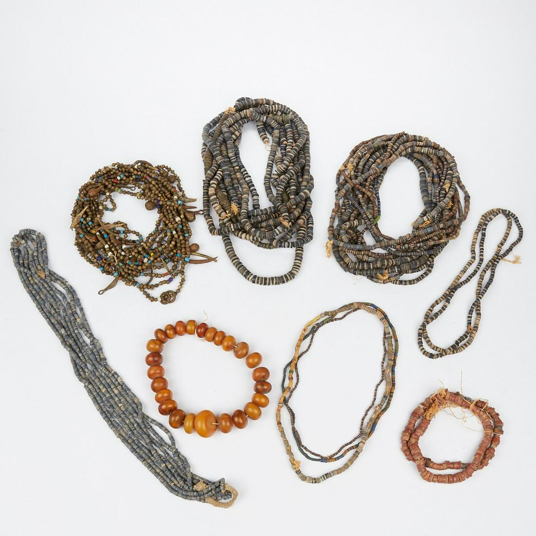 Grp: 8 African Trade Bead Necklaces: Group of eight African trade bead necklaces including bakelite faux egg yolk amber and many strings of glass metal and stone beads.