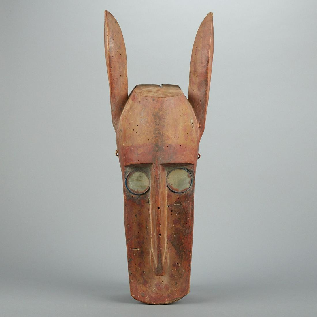 Bambara African Horse or Hyena Dance Mask: Bambara carved wood dance mask of a horse or hyena Mali. The mask is decorated with pierced holes and spotted polychrome decoration. Height: 27 1/2 in x width: 10 in x depth: 8 1/2 in.