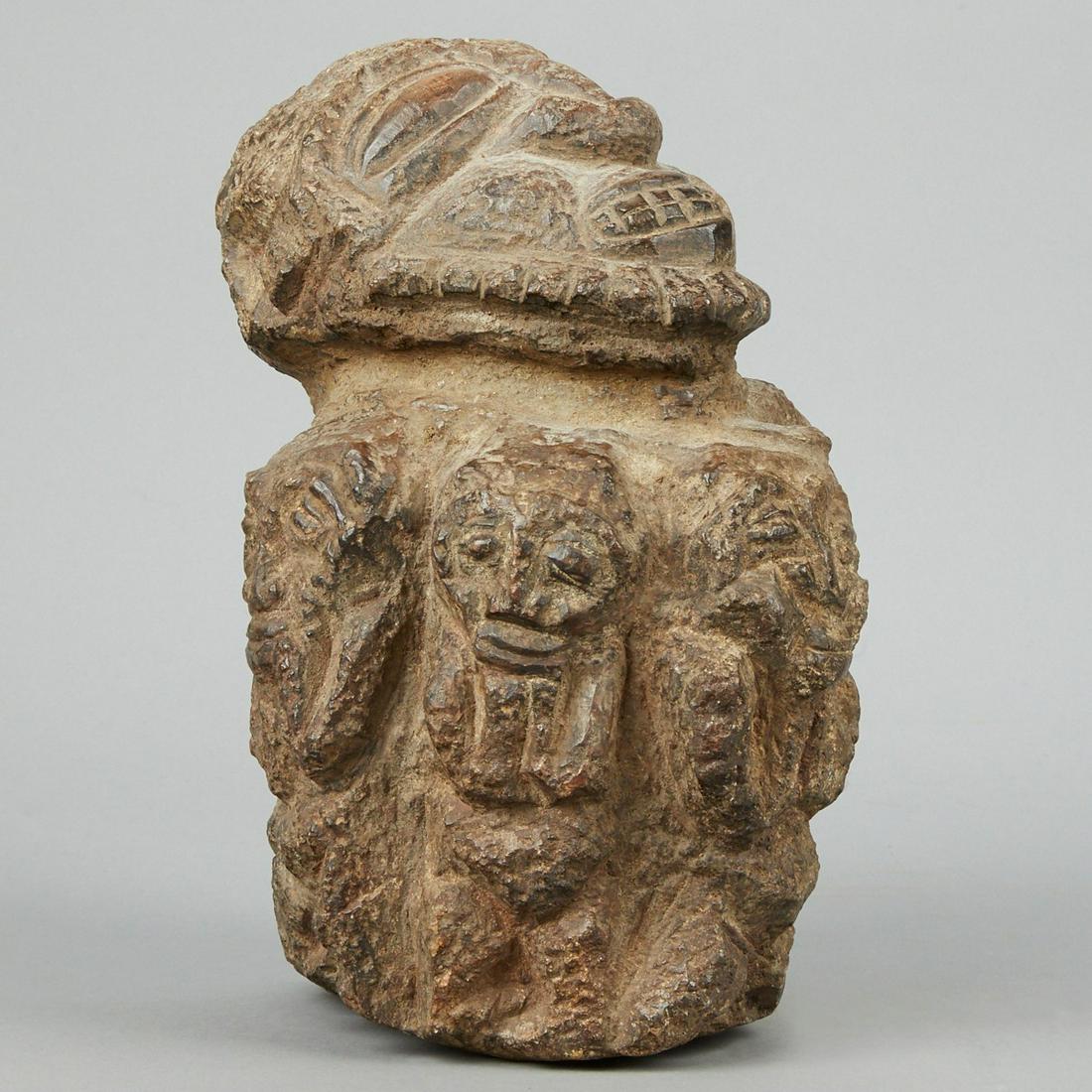 Kissi African Stone Figure Guinea 19th c.: Kissi (Kisi) stone figure Guinea 19th c. or earlier. This sculpture depicts a central figure with head tilted back and a detailed carved face and hairstyle surrounded by six smaller figures all holdin