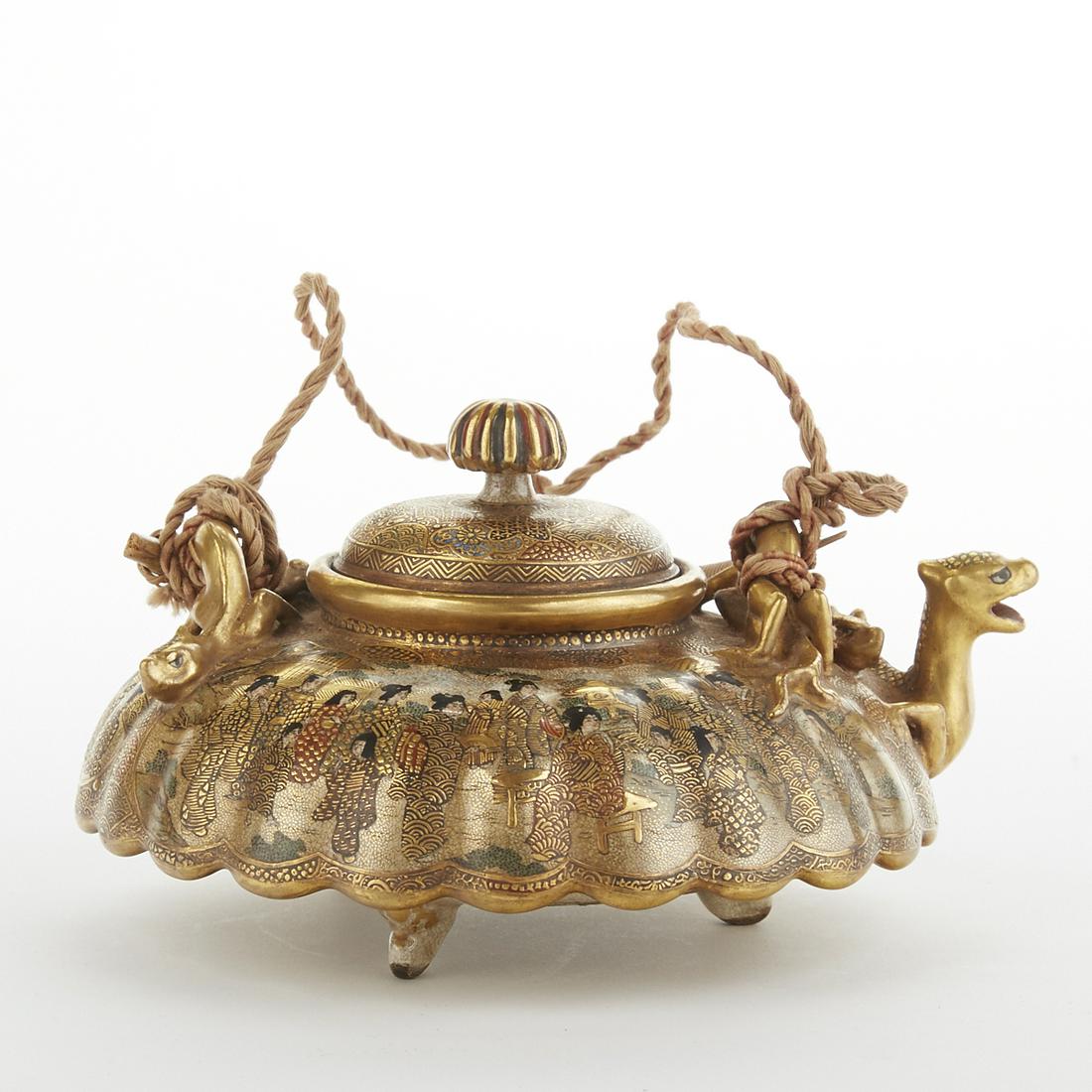 Japanese Meiji Satsuma Teapot: Japanese Meiji period satsuma teapot decorated with two gilt dragons with fitted wooden box. Marked along the underside. Height: 3 1/2 in x width: 6 1/2 in x depth: 6 in.