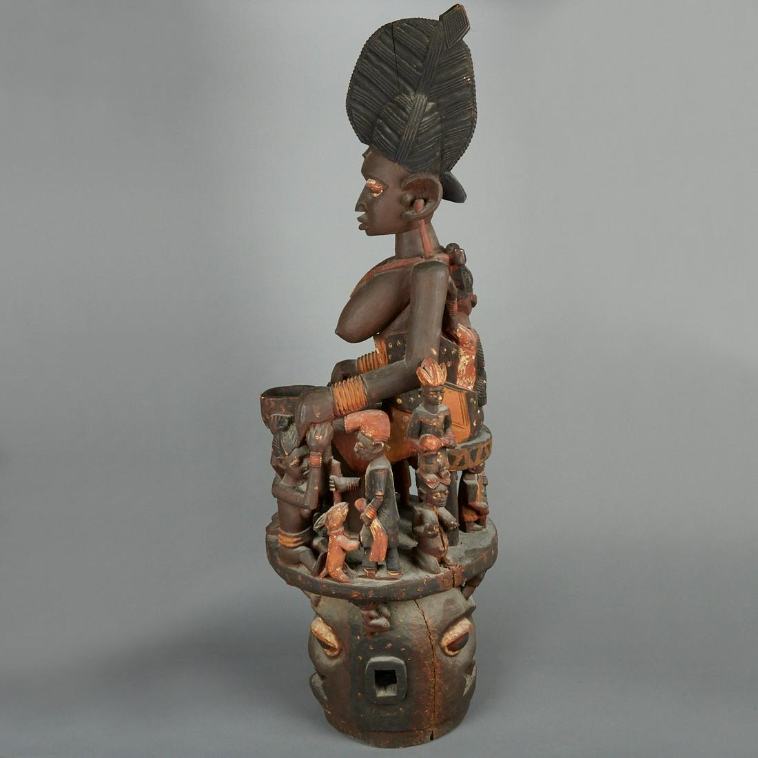 Massive African Yoruba Epa Helmet Mask: Yoruba Epa helmet mask, Nigeria. The Janus faced helmet mask is surmounted by a highly detailed figural superstructure with a large central female figure with an elaborate hairstyle surrounded by smal