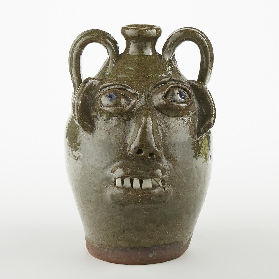 B.B. Craig North Carolina Folk Art Face Jug: B.B. Craig (1914-2002). Southern folk art ceramic stoneware face jug with alkaline glaze and porcelain teeth. Impressed mark along the underside: "B.B. Craig, Vale, N.C. [North Carolina]." H
