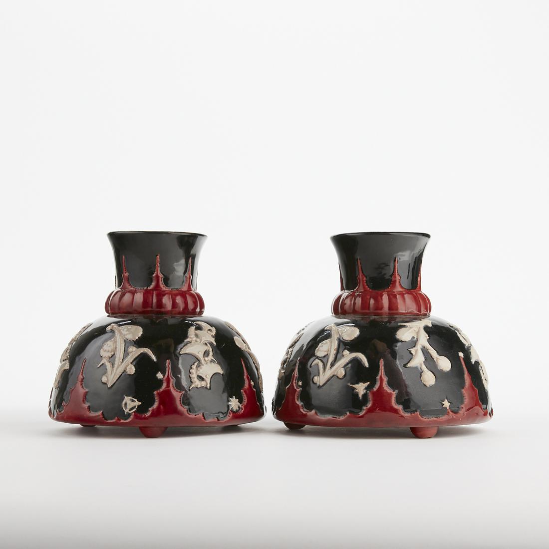 Pair of Karau Werkstatte Austrian Art Deco Vases: Fritz Pohl (20th c.) for Karau Werkstatte, Austria. Pair of ceramic vases with floral decoration in low relief, glazed in black, red, and white. Both with impressed marks along the underside. Height: 