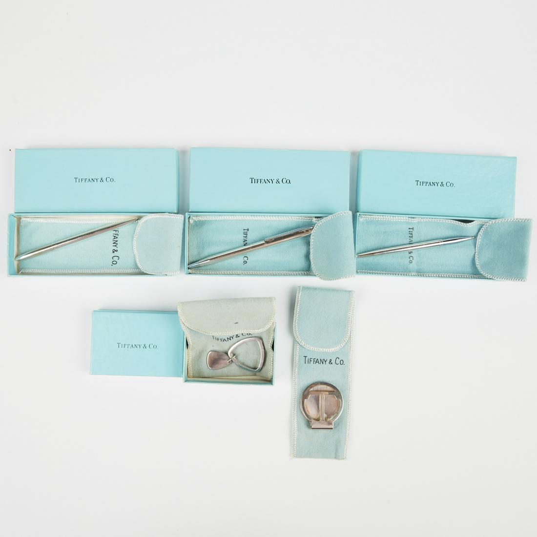Grp: 20th c. Tiffany Objects: Group of 20th century Tiffany Co. objects with their original packaging, comprised of a three sterling silver ballpoint pens, a sterling silver triangular key ring, and a sterling silver T money clip.