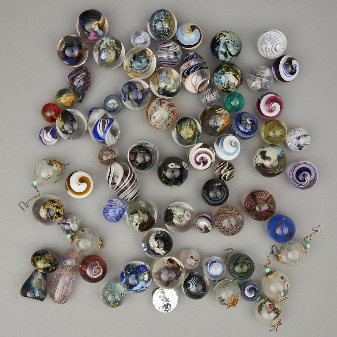 Large Group of Studio Glass Marbles: Large group of glass marbles and other small glass objects. Includes many lovely blown glass marbles in Venetian, Murano, and millefiori styles. Height ranges from 7/8 in to 2 in; diameter ranges from