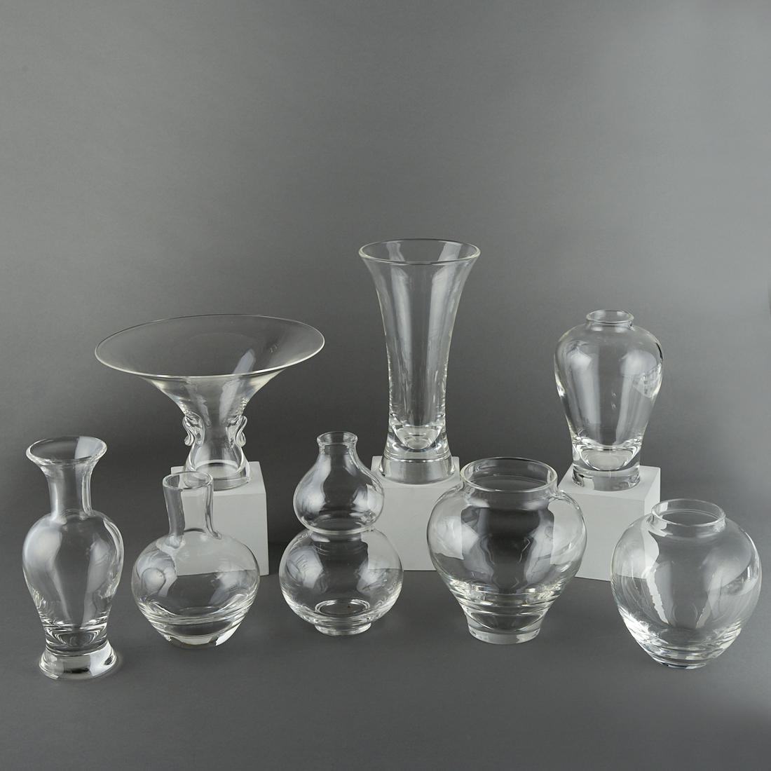 Grp: 8 Steuben Crystal Glass Vases: Steuben, USA. Group of eight Steuben crystal glass vases. Each marked "Steuben" along the underside. Height ranges from 6 1/4 in to 9 3/4 in; diameter ranges from 3 1/2 in to 9 5/8 in.
