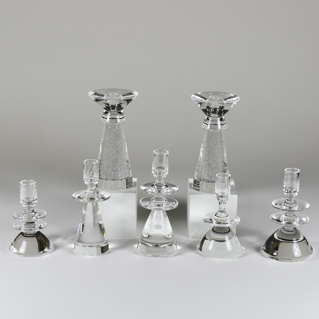 Pair of David Dowler Steuben Crystal Candlesticks w/ 5: David Dowler (b. 1945) for Steuben Crystal, USA. Pair of glass crystal candlesticks by David Dowler along with five glass Steuben candlesticks in an accompanying case. Each marked "Steuben"